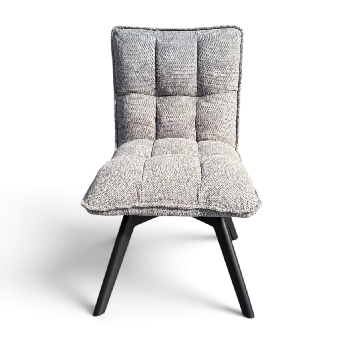 Pieces For Places Bubble grey fabric swivel dining chair with a tufted seat and sleek black metal legs.