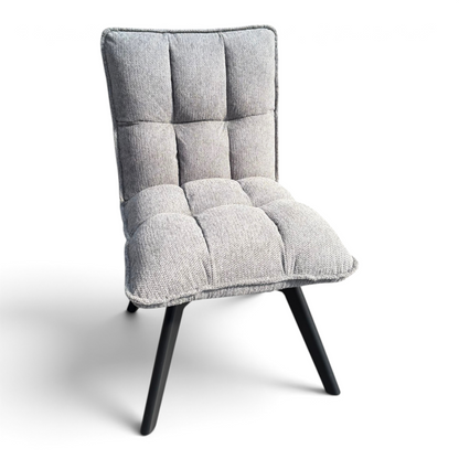 Pieces For Places Bubble grey fabric swivel dining chair with a cushioned seat and black metal legs in a warehouse