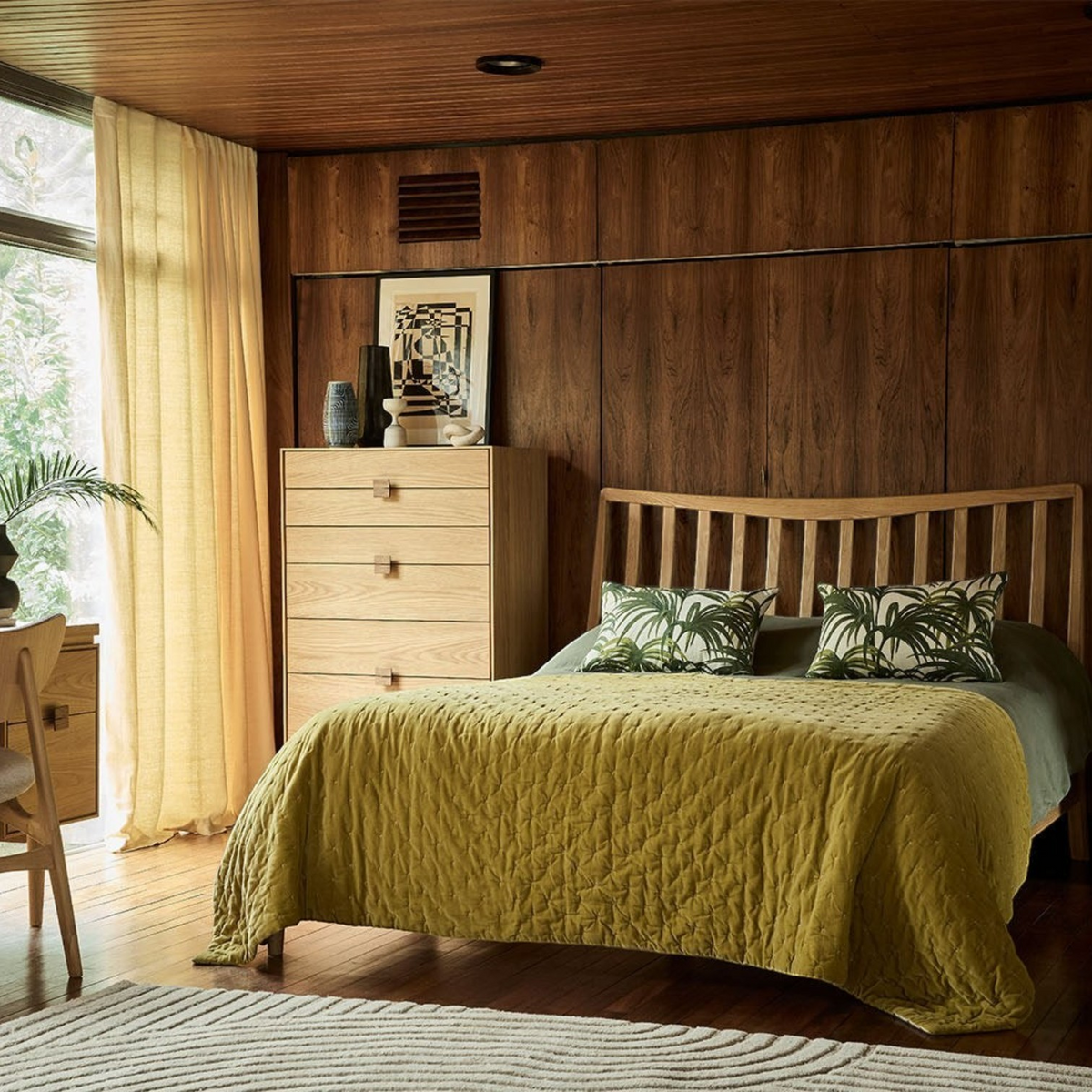 Pieces For Places Larsen 6 drawer tall chest in light wood finish, styled in a modern bedroom with matching furniture.