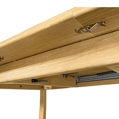 Pieces For Places Larsen extending dining table showing the underside mechanism, metal hinges, and natural wood grain.
