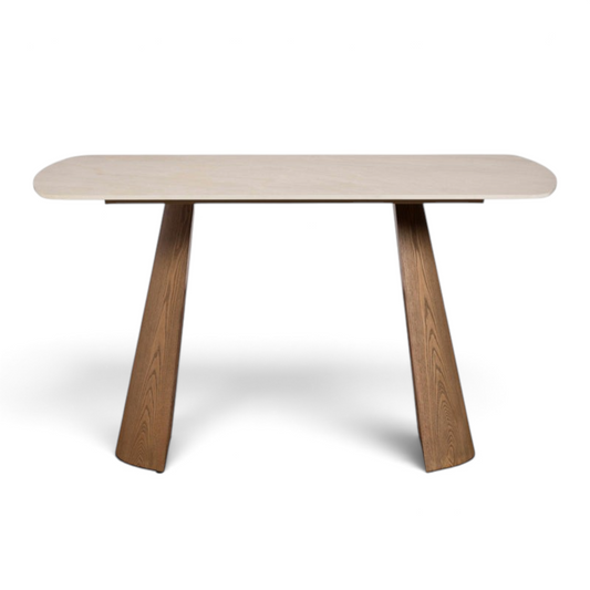 Pieces For Places Lusso 135cm dining table with a light sintered stone top and angled ash veneered wooden legs.