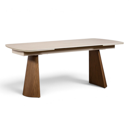 Pieces For Places extending dining table with a cream sintered stone top and curved ash-veneered wooden legs.