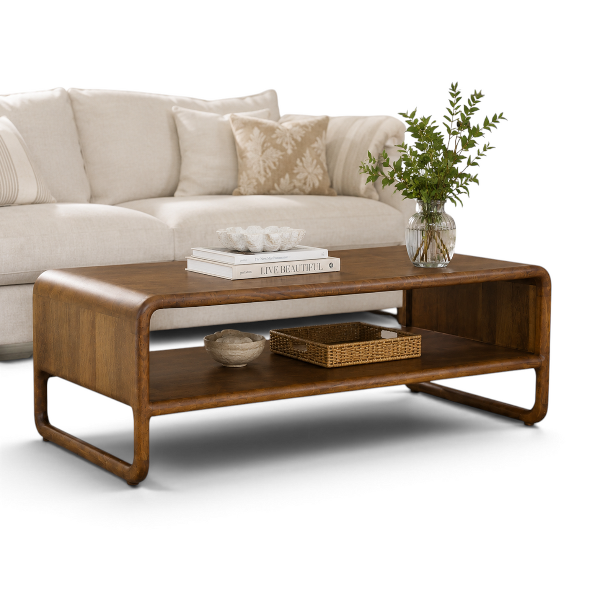 Pieces For Places Saturn coffee table in warm mango wood with rounded edges and a lower storage shelf in a living room