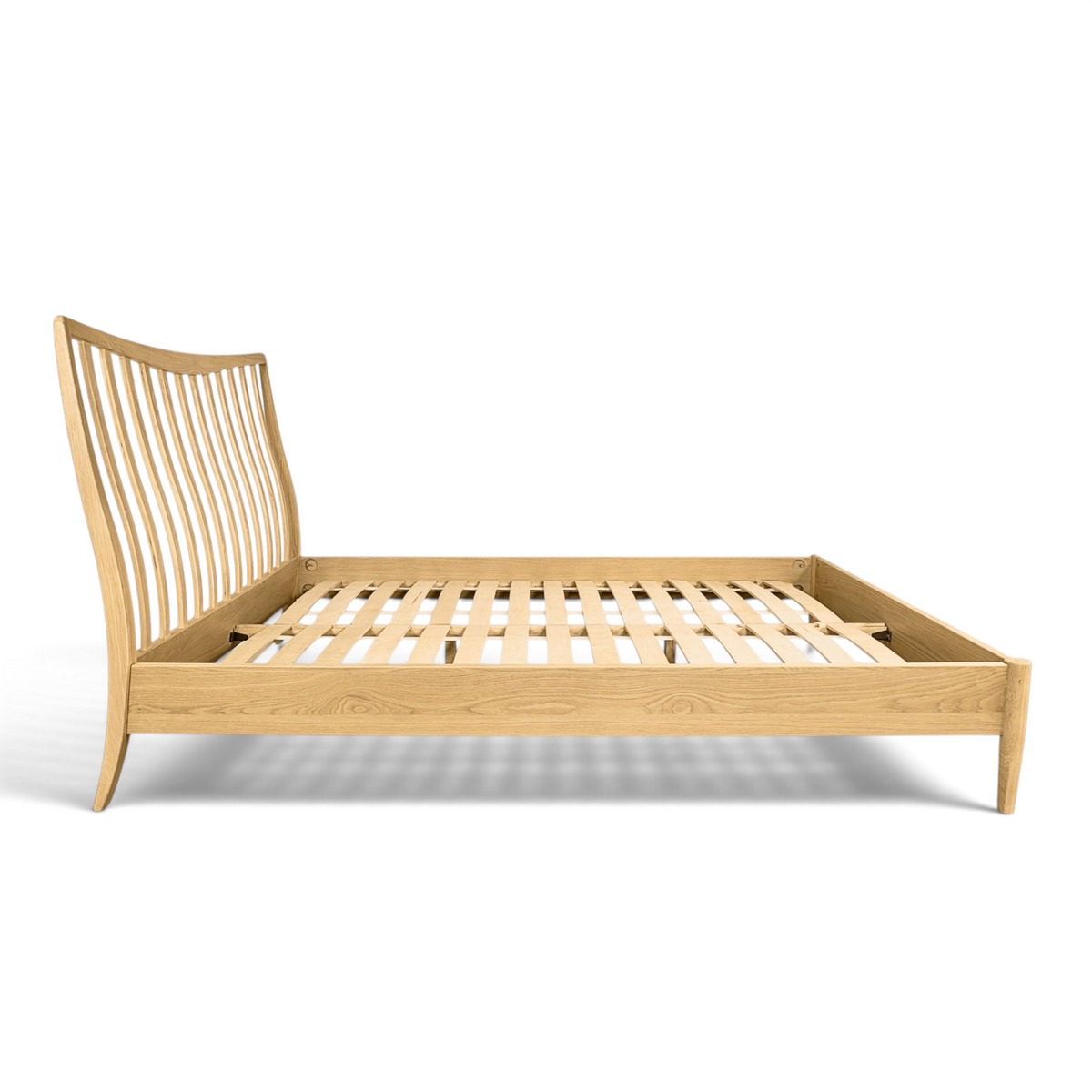 Pieces For Places Larsen oak bed frame with a curved spindle headboard and slatted base in a Danish design style.