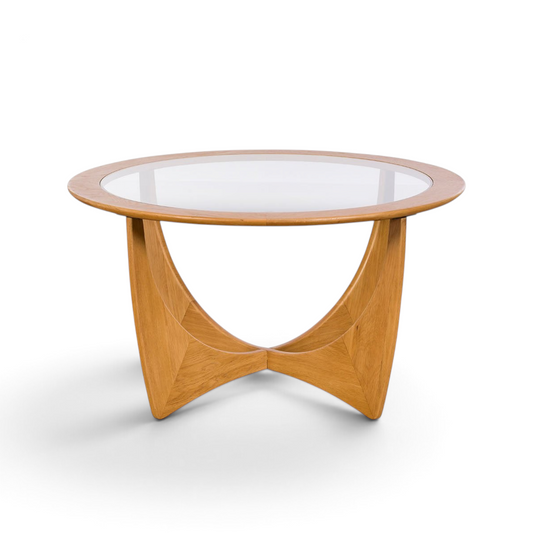 Pieces For Places Larsen round coffee table with a glass top and sculptural light wood base in mid-century style.