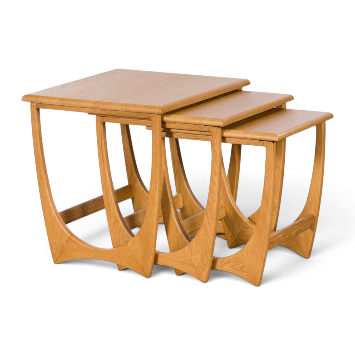 Pieces For Places Larsen nest of three light oak tables with curved Danish-inspired legs on a white background