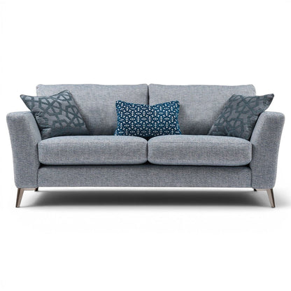 Pieces For Places Florence 2.5 Seater Sofa in grey textured fabric with reversible seat cushions and decorative blue scatter cushions.