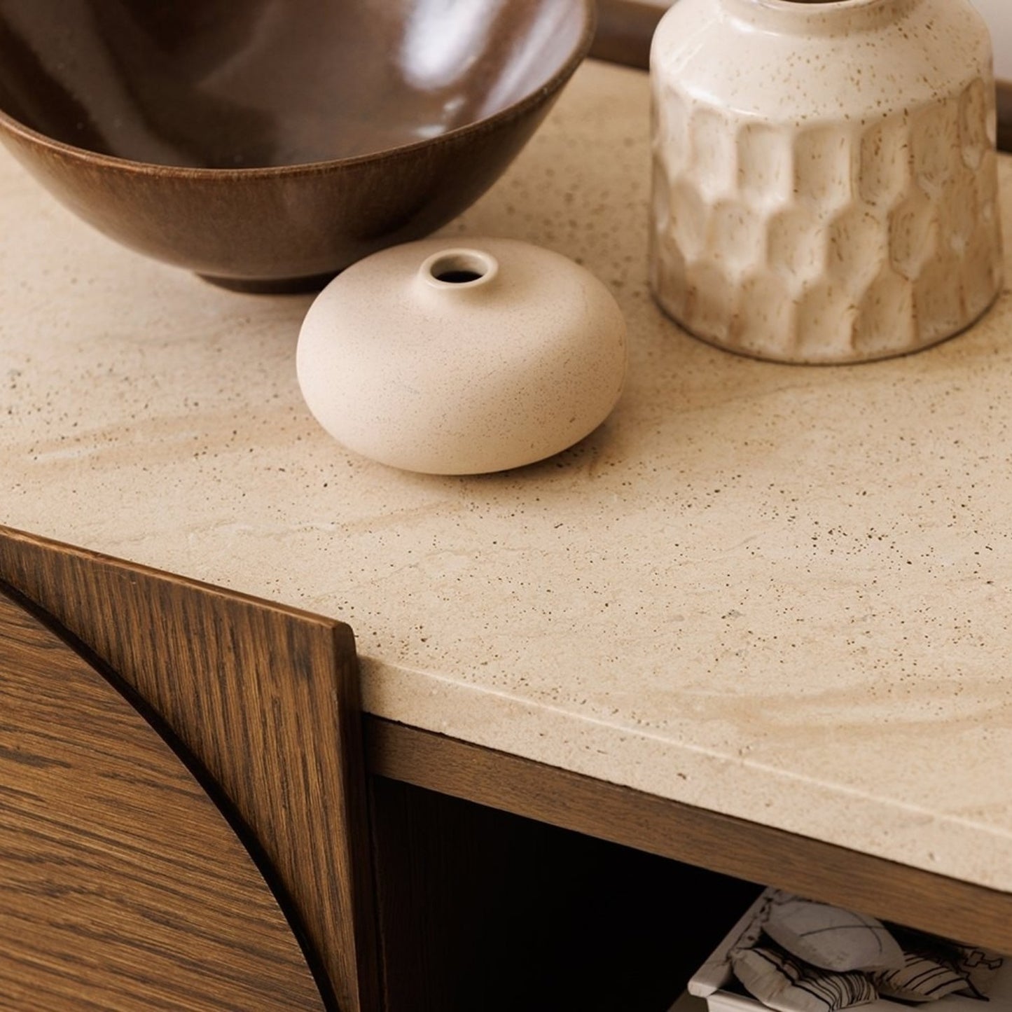Pieces For Places Ida media unit featuring a travertine effect stone top and dark walnut oak wood frame with decor.