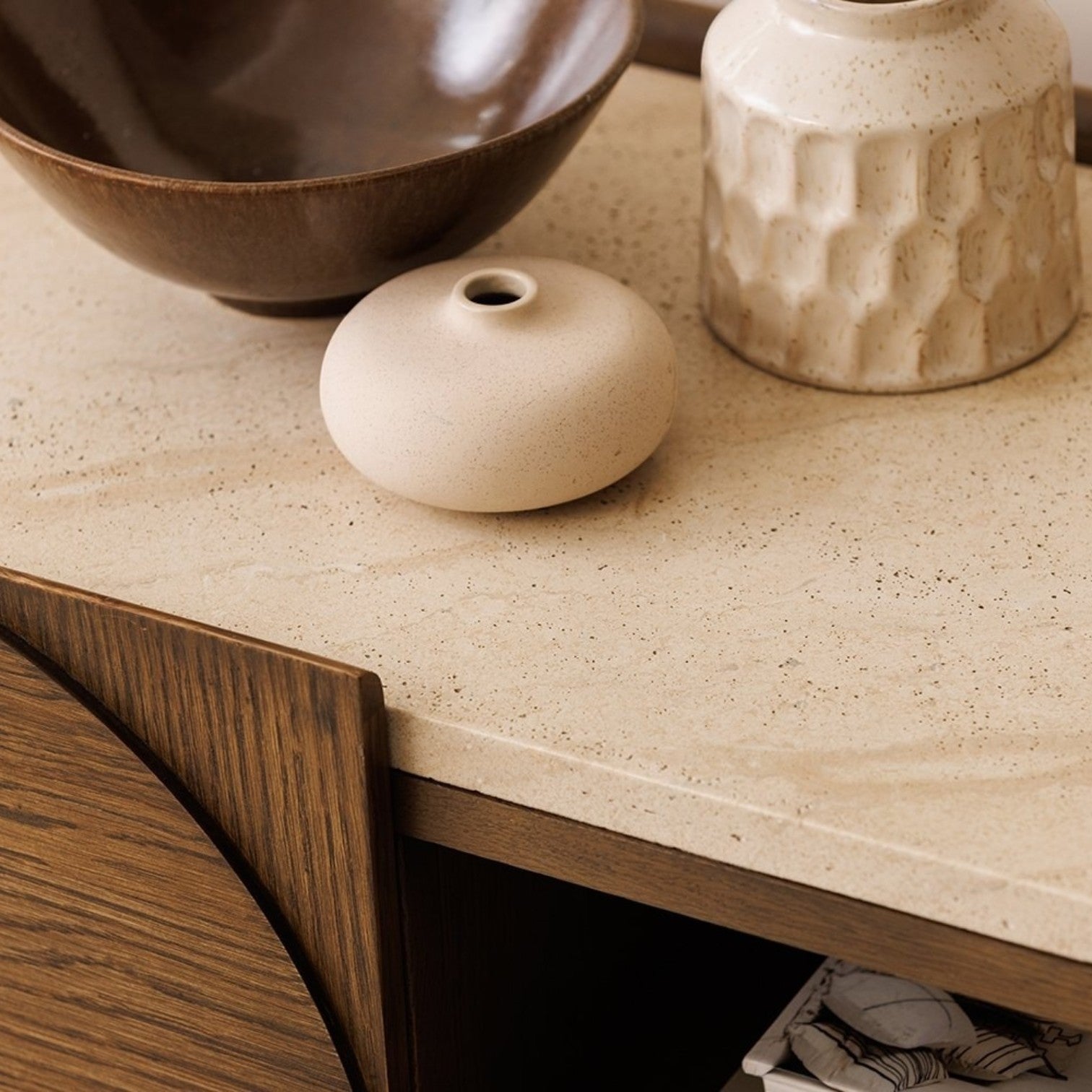 Pieces For Places Ida media unit featuring a travertine effect stone top and dark walnut oak wood frame with decor.