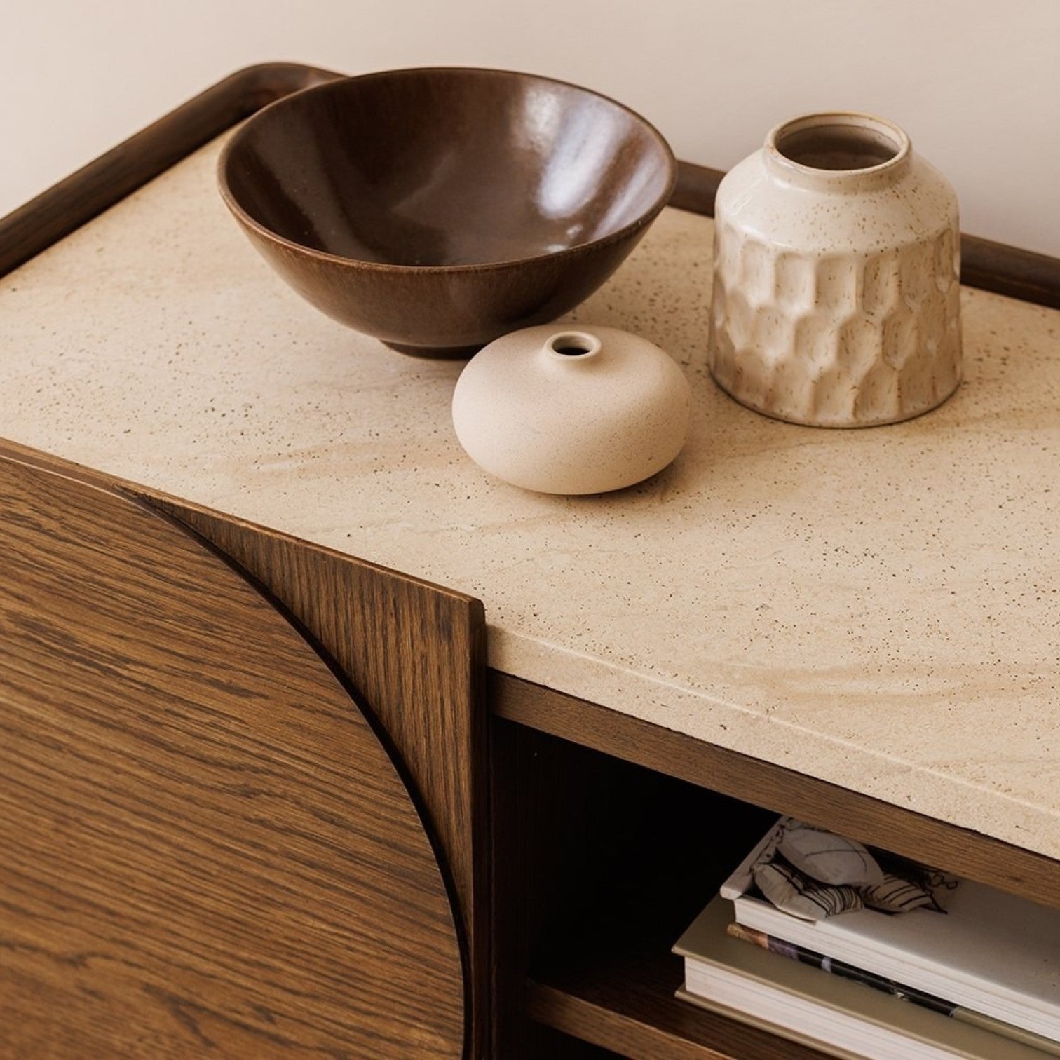 Pieces For Places Ida media unit with walnut finish oak frame and travertine effect concrete top, close-up view.