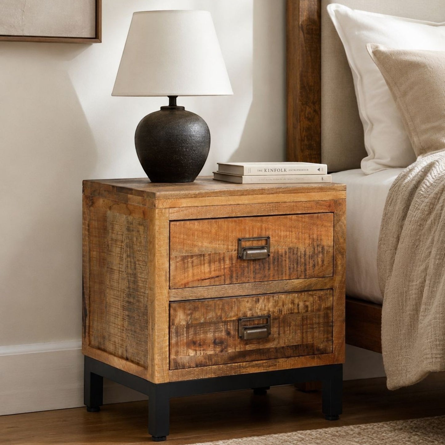 Pieces For Places industrial mango wood side table with two drawers, metal cup handles, and a black metal base.
