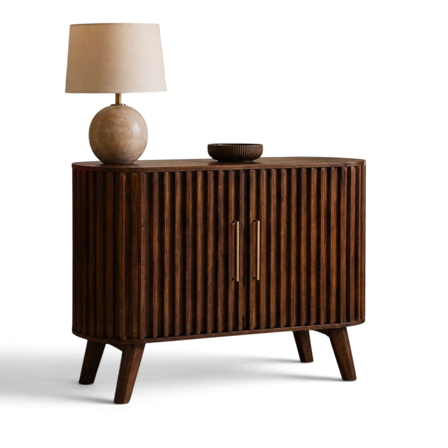 Pieces For Places Mason dark mango wood sideboard with fluted doors, curved ends, and gold handles in a living room.