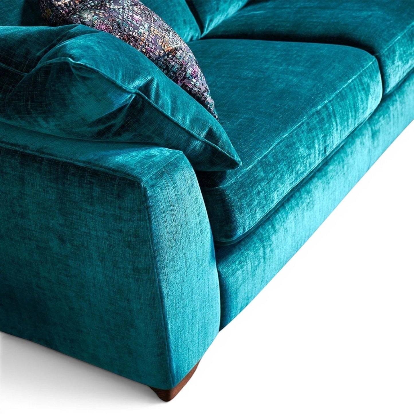 Pieces For Places Milo 2 Seater Sofa in teal velvet with plush seat and back cushions and a patterned scatter cushion.