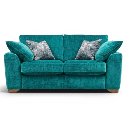 Pieces For Places teal velvet 2 seater sofa with plush seat and back cushions and patterned scatter cushions.