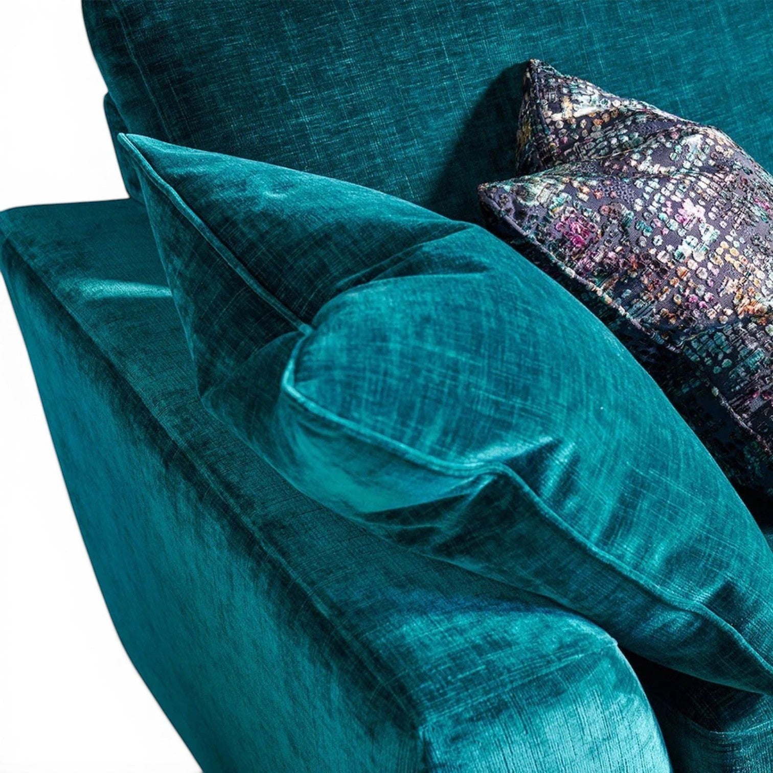 Pieces For Places Milo 2.5 Seater Sofa in teal velvet with patterned scatter cushions.