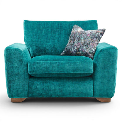 Pieces For Places Milo Armchair in teal textured fabric with a patterned scatter cushion and wooden feet.