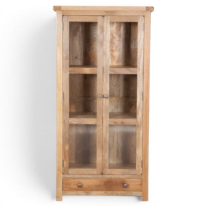 Pieces For Places Olda Glazed Display Cabinet in natural mango wood with three shelves, two glass doors, and a bottom drawer. Rustic farmhouse style.