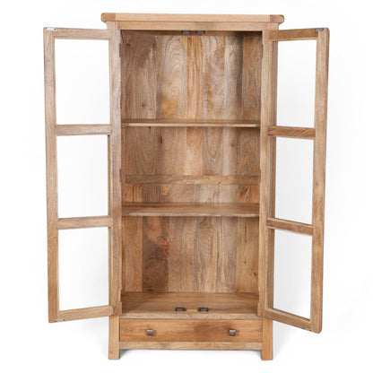 Pieces For Places Olda Glazed Display Cabinet in natural mango wood with three shelves, two glass doors, and a drawer.