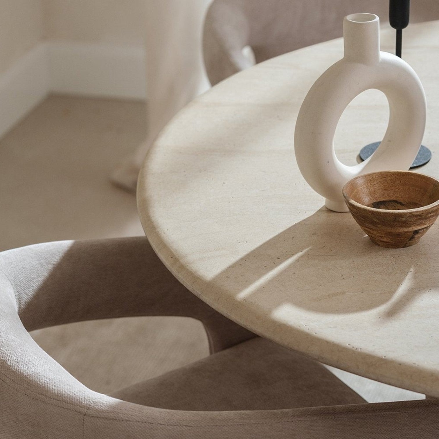 Pieces For Places Ida 120cm round dining table with a beige travertine finish and a modern column base.