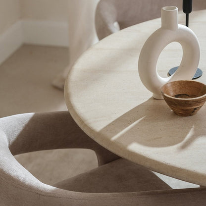 Pieces For Places Ida 120cm round dining table with a beige travertine finish and a modern column base.