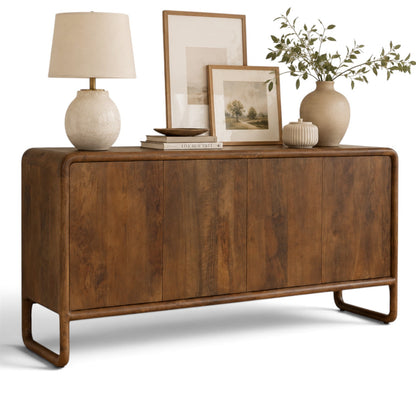 Pieces For Places Saturn 4-door sideboard in warm mango wood with a curved frame and handleless design.