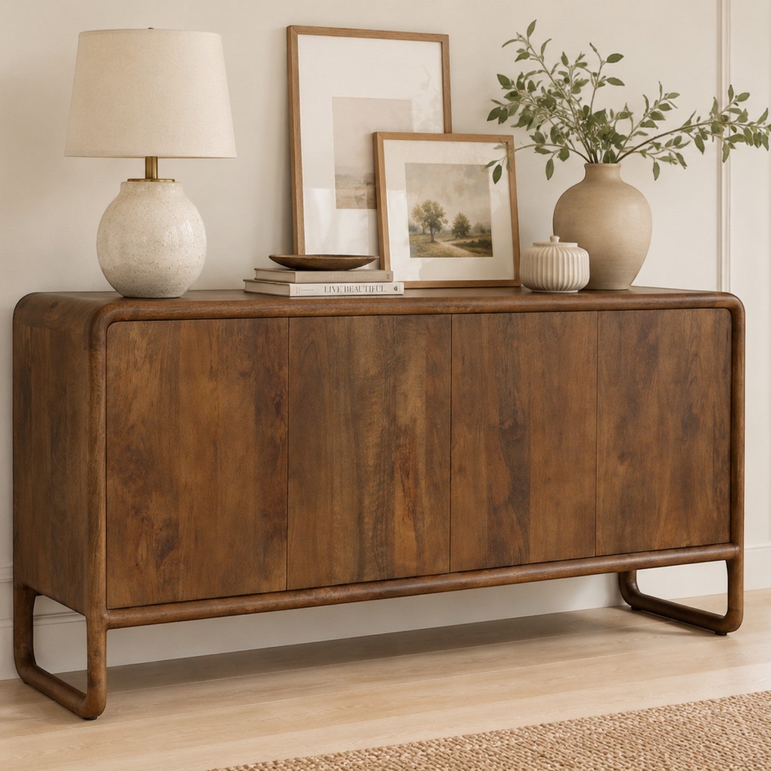 Pieces For Places Saturn 4 door sideboard in warm mango wood with a curved frame and handleless design