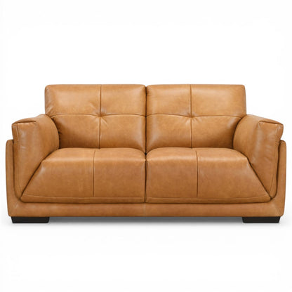 Pieces For Places Theo tan leather 2-seater sofa with tufted back cushions and low-profile dark wood feet.